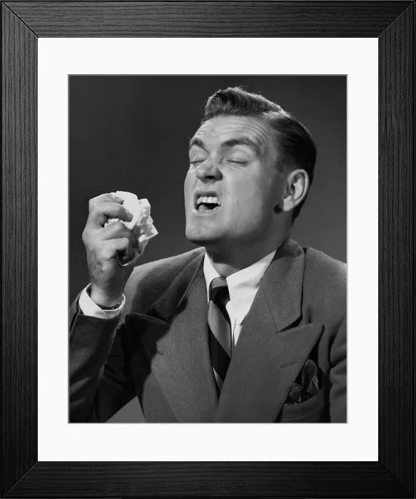 Framed Print : Bless You. A smartly-dressed man in the middle of a sneeze, circa 1955 Framed Print : Bless You. A smartly-dressed man in the middle of a sneeze, circa 1955