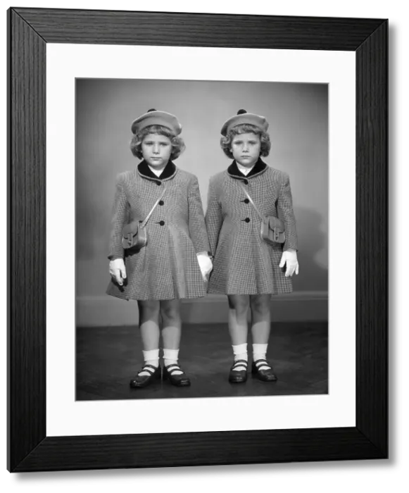 Framed Print : Twin girls in hats & coats wearing white gloves Framed Print : Twin girls in hats & coats wearing white gloves