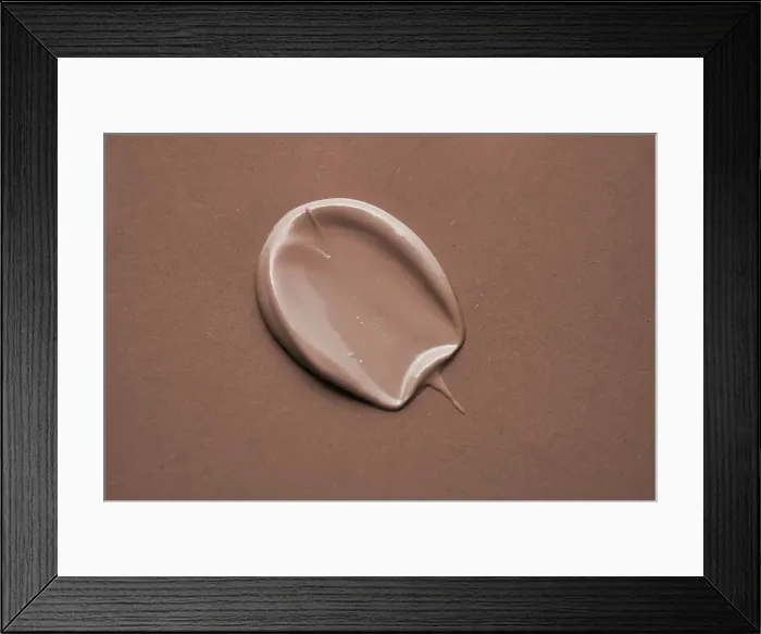 Framed Print : Beige cosmetic cream swatch on a Mocha color background. Color of the Year 2025