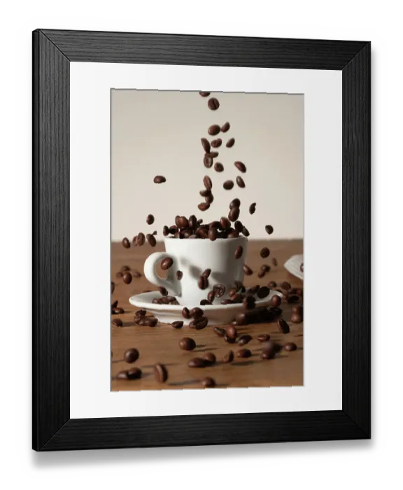 Framed Print : Coffee beans being poured into a cup Framed Print : Coffee beans being poured into a cup