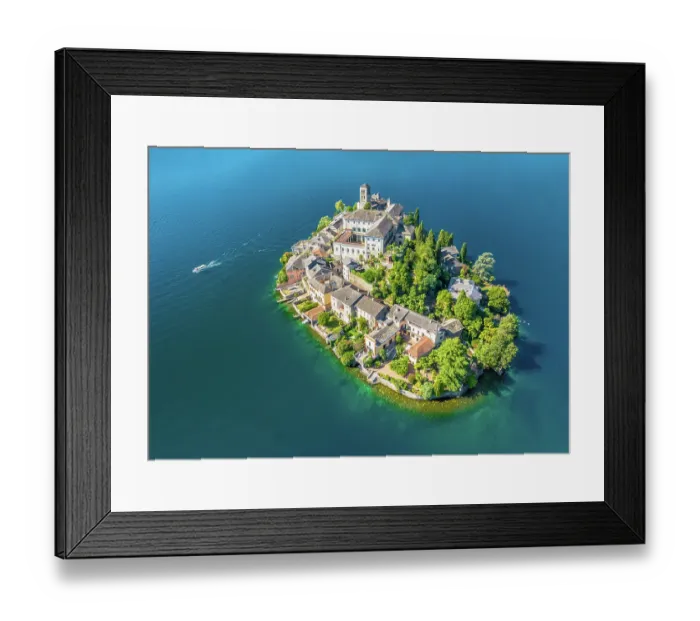 Framed Print : A small ferry leaving Isola San Giulio (St. Julius Island) in Lake Orta, Italy Framed Print : A small ferry leaving Isola San Giulio (St. Julius Island) in Lake Orta, Italy