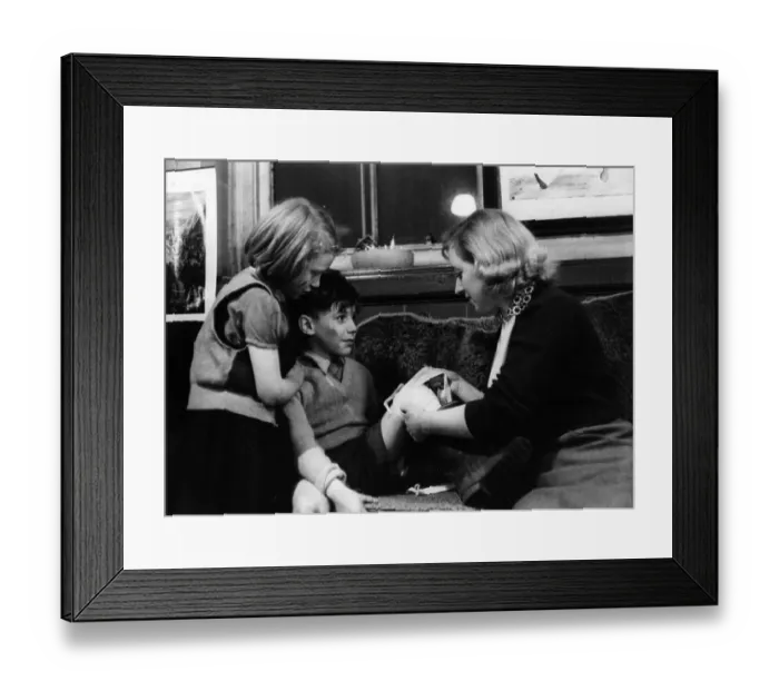 Framed Print : Cut Leg. 4th February 1956: One of the teachers treats an injury sustained by a male pupil Framed Print : Cut Leg. 4th February 1956: One of the teachers treats an injury sustained by a male pupil