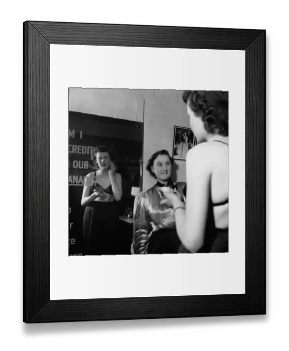 Framed Print : Usherette. circa 1955: A cinema usherette in the staff room puts on her make up Framed Print : Usherette. circa 1955: A cinema usherette in the staff room puts on her make up