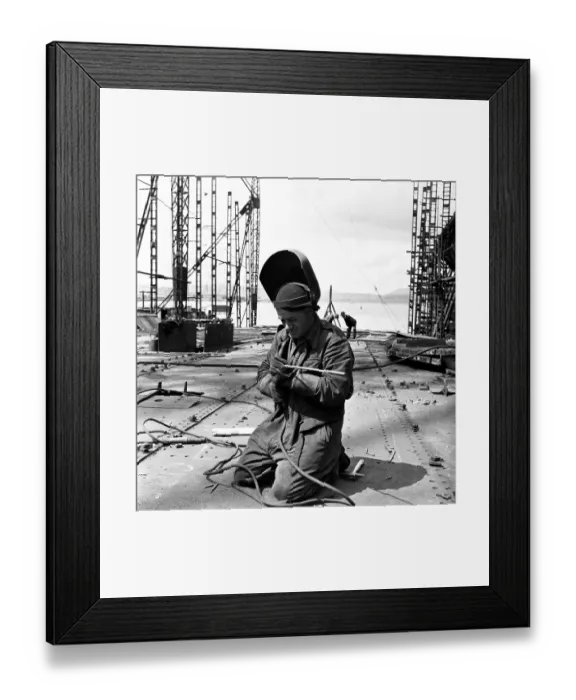 Framed Print : Dry Dock. 17th July 1954: A welder gets to work at a shipyard on the River Framed Print : Dry Dock. 17th July 1954: A welder gets to work at a shipyard on the River