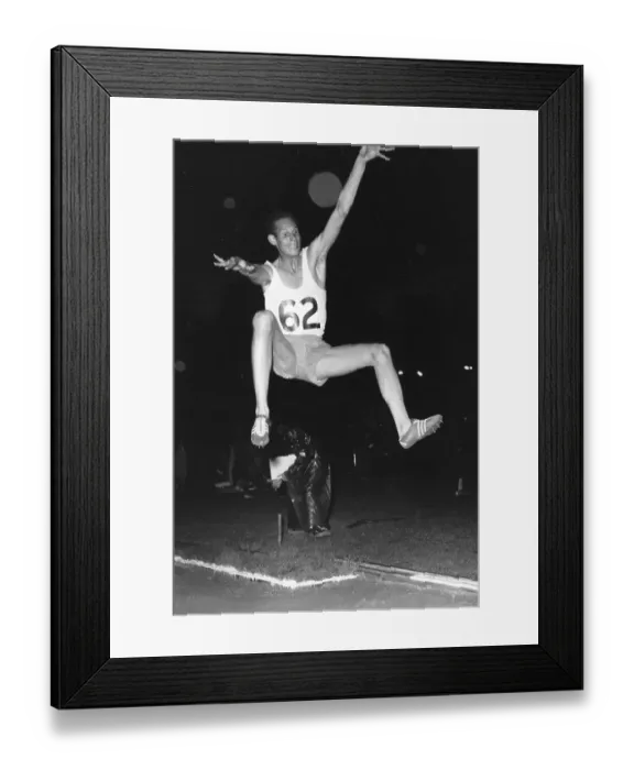 Framed Print : Long Jump. H Visser in the midst of his winning jump at White City, west London Framed Print : Long Jump. H Visser in the midst of his winning jump at White City, west London