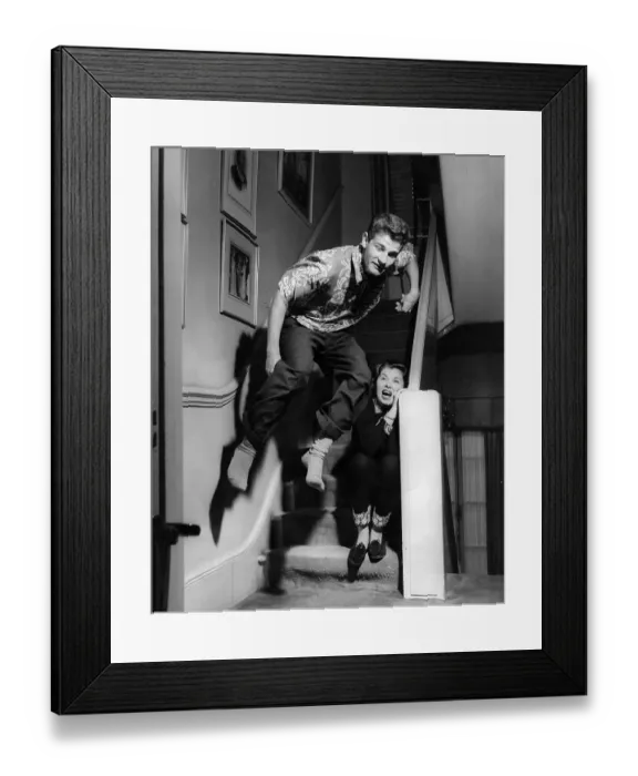 Framed Print : The Lyons children fool about on the stairs during the film adaptation Framed Print : The Lyons children fool about on the stairs during the film adaptation