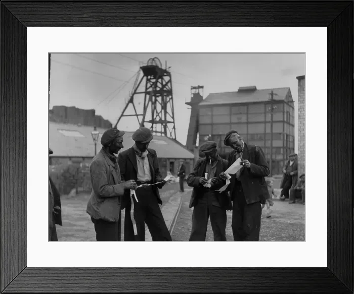 Framed Print : Pay Slips. 21st October 1950: Miners, who have just completed a shift at Framed Print : Pay Slips. 21st October 1950: Miners, who have just completed a shift at