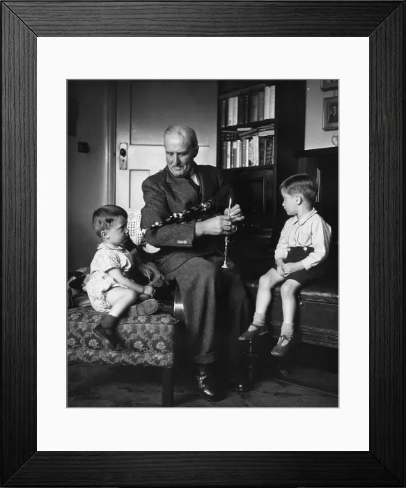 Framed Print : Bagpipes. 21st October 1950: A grandfather shows his grandchildren his Framed Print : Bagpipes. 21st October 1950: A grandfather shows his grandchildren his