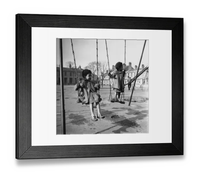 Framed Print : Swingers. 22nd April 1950: Children playing on the swings in a park in Framed Print : Swingers. 22nd April 1950: Children playing on the swings in a park in