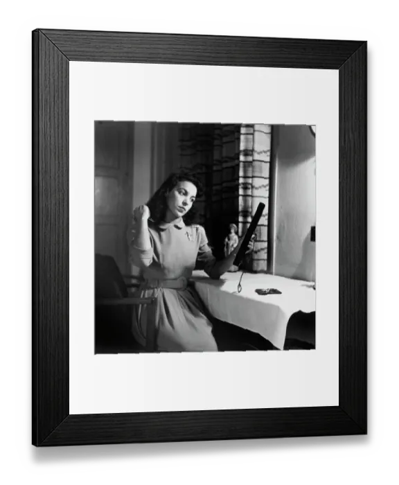 Framed Print : Tiger Bay. A woman brushing her hair in front of a mirror at home in Tiger Framed Print : Tiger Bay. A woman brushing her hair in front of a mirror at home in Tiger
