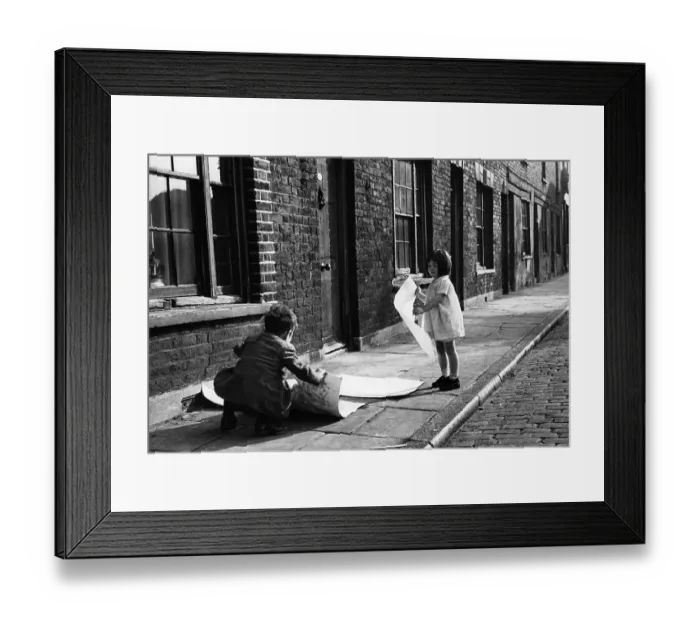Framed Print : Roll Up. 3rd December 1949: Children playing games on Wapping High Street in London Framed Print : Roll Up. 3rd December 1949: Children playing games on Wapping High Street in London