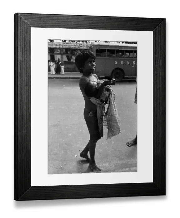 Framed Print : Please !. 8th March 1947: A young child carrying a baby begs in the streets Framed Print : Please !. 8th March 1947: A young child carrying a baby begs in the streets