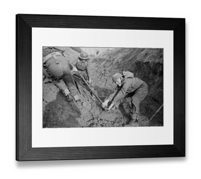 Framed Print : Hard Work. A group of soldiers attempt to move a six-pounder anti-tank Framed Print : Hard Work. A group of soldiers attempt to move a six-pounder anti-tank