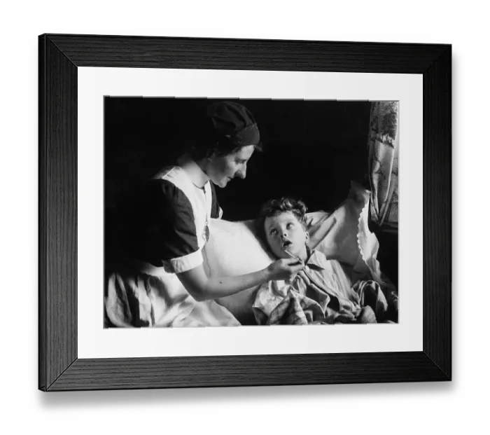 Framed Print : Feverish. 6th June 1942: A district nurse takes the temperature of a sick child Framed Print : Feverish. 6th June 1942: A district nurse takes the temperature of a sick child