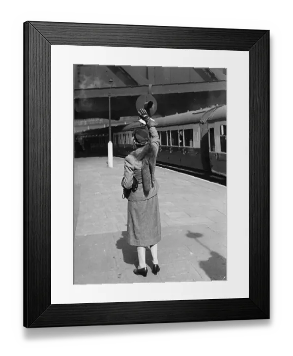 Framed Print : Farewell. 23rd May 1942: A lone woman stands on an empty platform waving Framed Print : Farewell. 23rd May 1942: A lone woman stands on an empty platform waving