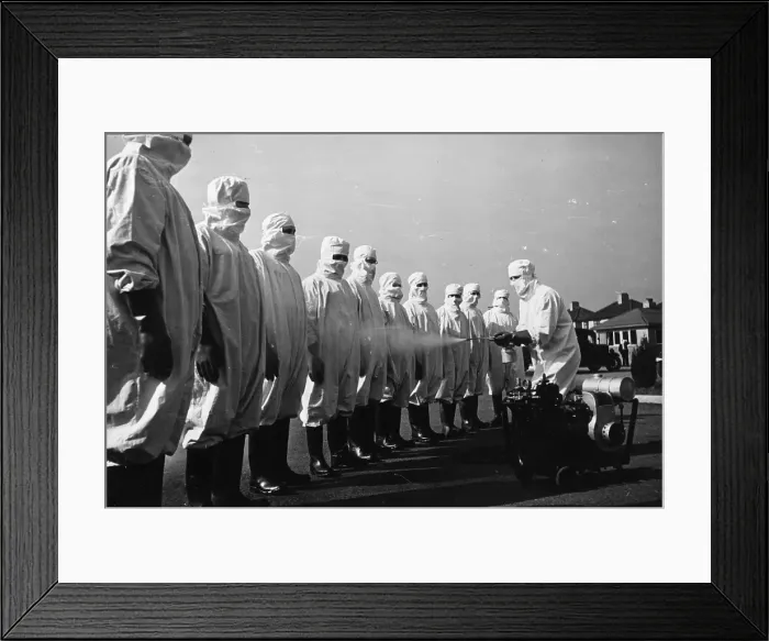 Framed Print : Hose Down. 9th May 1942: A line of men being hosed down as they may have Framed Print : Hose Down. 9th May 1942: A line of men being hosed down as they may have