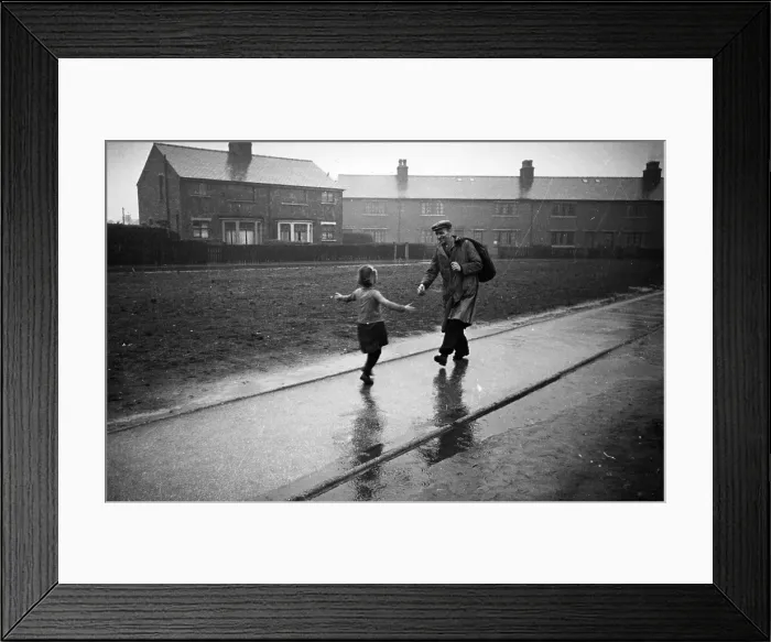 Framed Print : Hello Dad. 21st March 1942: A little girl runs to meet her father on his return from work Framed Print : Hello Dad. 21st March 1942: A little girl runs to meet her father on his return from work