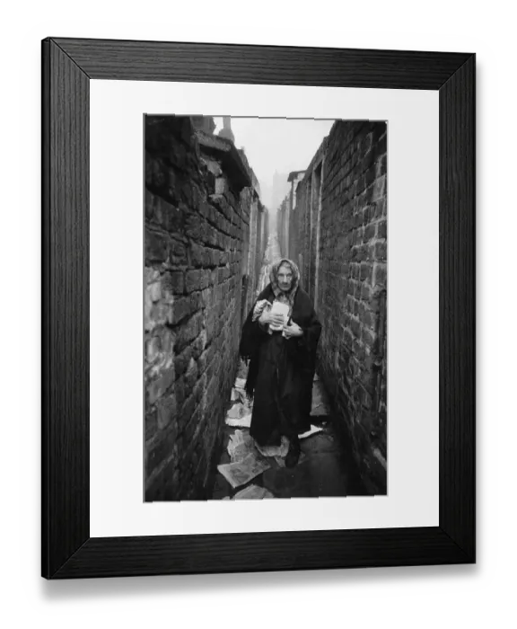Framed Print : Old Woman. An elderly woman standing amongst the litter in a back alley Framed Print : Old Woman. An elderly woman standing amongst the litter in a back alley