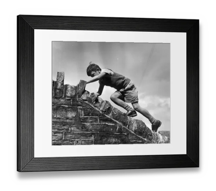Framed Print : Sole Heir. July 1955: One of the children of Street in Somerset puts a Framed Print : Sole Heir. July 1955: One of the children of Street in Somerset puts a