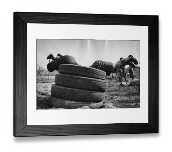 Framed Print : Tyre Dive. Two boys diving through some tyres Framed Print : Tyre Dive. Two boys diving through some tyres