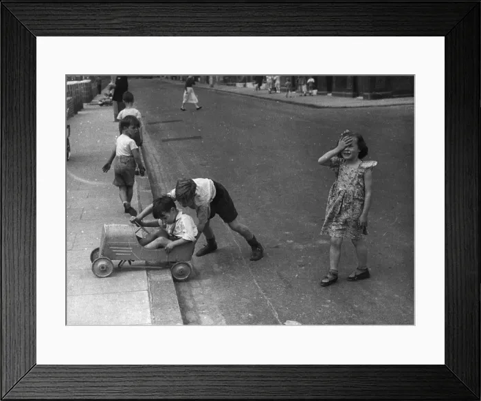 Framed Print : Playtime. 7th August 1954: A group of children playing in a London street