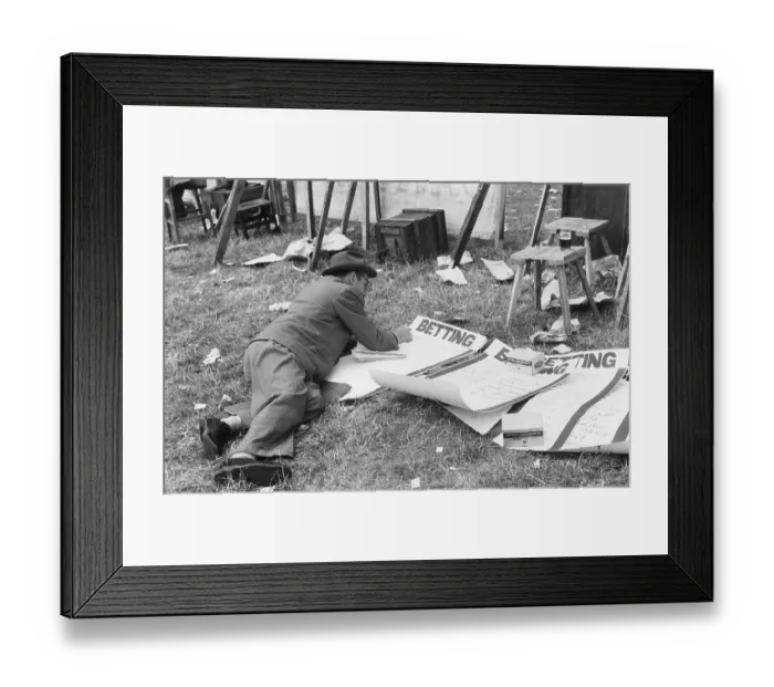Framed Print : Odds On. 11th August 1952: A bookie at the Brighton races writing up the odds
