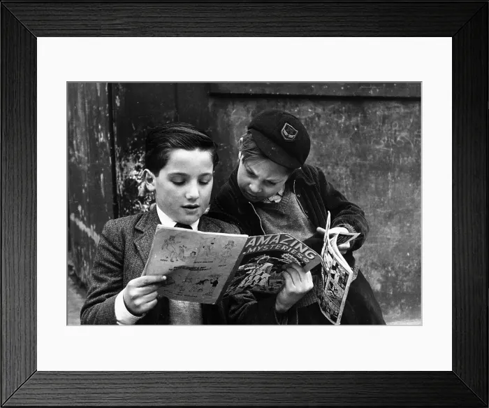 Framed Print : Coo !. 17th May 1952: Two young boys reading comics
