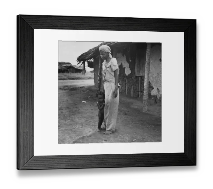 Framed Print : Shy Child. December 1951: A child hiding behind its mother at a fishing Framed Print : Shy Child. December 1951: A child hiding behind its mother at a fishing