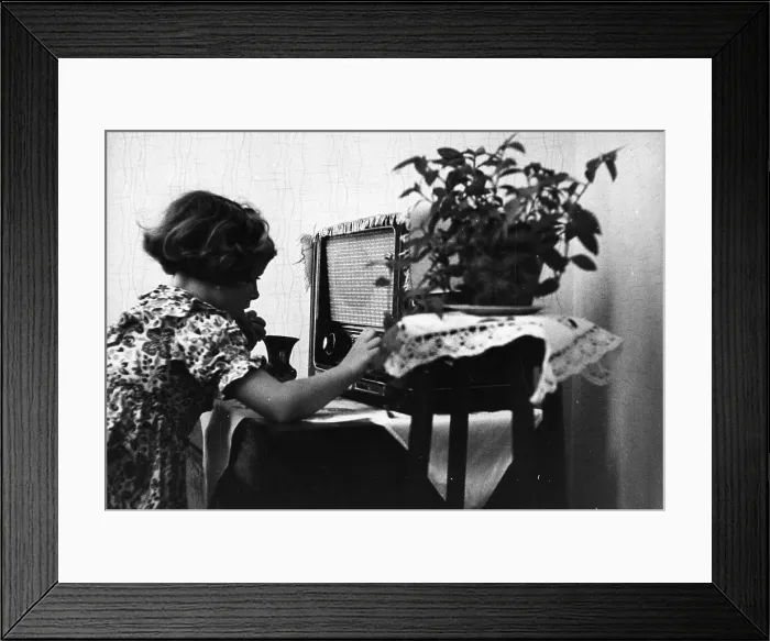 Framed Print : Tuning In. 26th November 1955: A child tunes in a radio at home Framed Print : Tuning In. 26th November 1955: A child tunes in a radio at home
