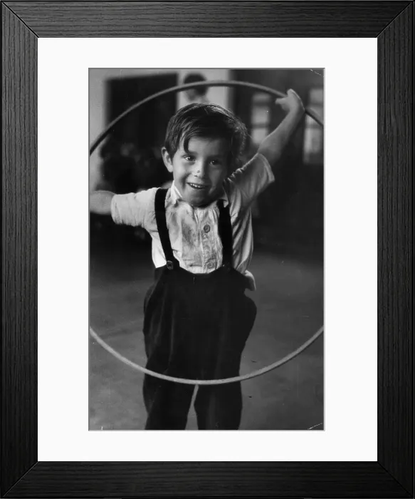 Framed Print : Hula Hoop. A young boy playing with a hula hoop in a nursery Framed Print : Hula Hoop. A young boy playing with a hula hoop in a nursery