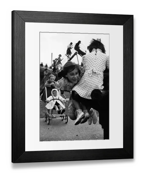 Framed Print : Swings. 1950: Children playing happily in their playground during a break