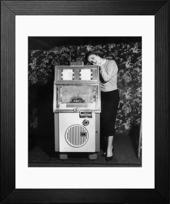 Framed Print : Dream On. February 1957: A young woman gets dewy-eyed with the music from a juke box Framed Print : Dream On. February 1957: A young woman gets dewy-eyed with the music from a juke box