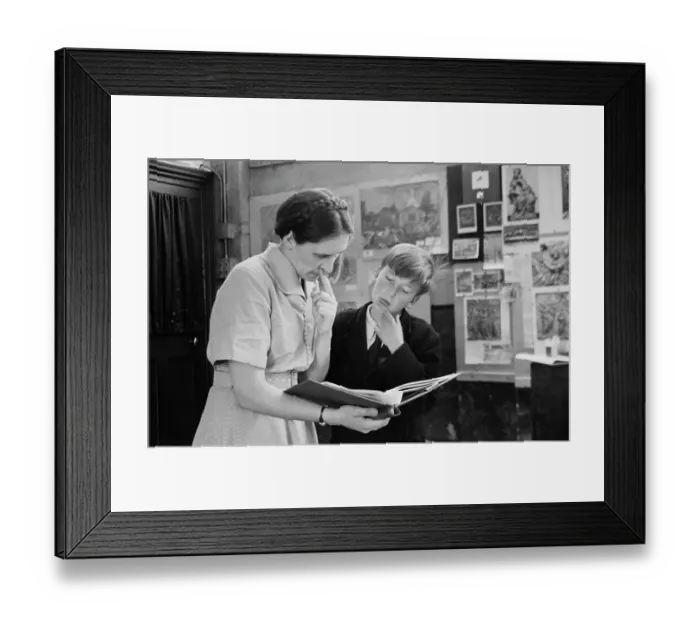 Framed Print : Art Class. A teacher and pupil looking over a portfolio in an art class Framed Print : Art Class. A teacher and pupil looking over a portfolio in an art class