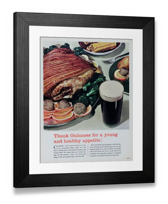 Framed Print : Guinness. 1956: A glass of stout ale is shown next to a dinner of roast pork Framed Print : Guinness. 1956: A glass of stout ale is shown next to a dinner of roast pork