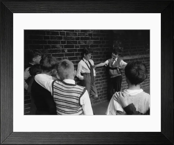 Framed Print : Bullying. 22nd June 1956: Children bullying a boy in a playground Framed Print : Bullying. 22nd June 1956: Children bullying a boy in a playground