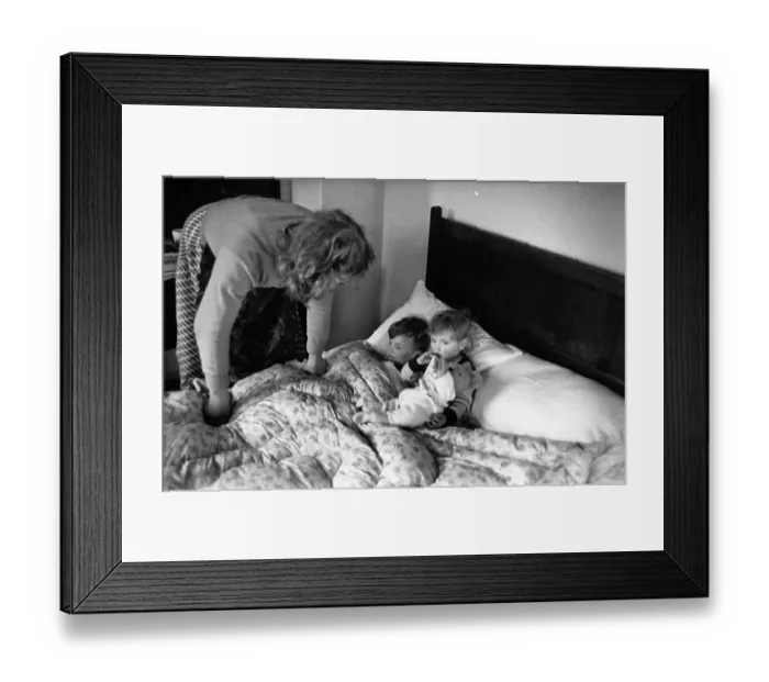 Framed Print : Bedtime. 10th March 1956: A mother tucks her two youngsters into bed Framed Print : Bedtime. 10th March 1956: A mother tucks her two youngsters into bed