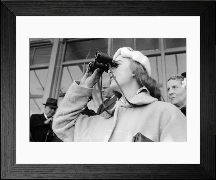 Framed Print : Good View. 18th April 1955: A woman peers at the racecourse through her binoculars Framed Print : Good View. 18th April 1955: A woman peers at the racecourse through her binoculars