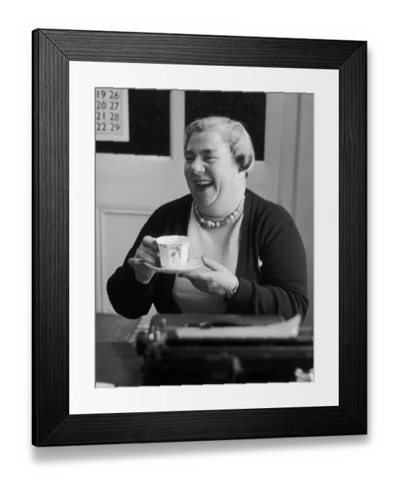 Framed Print : Tea Lady. 5th February 1955: Mrs Stark enjoys a cup of tea at her typewriter Framed Print : Tea Lady. 5th February 1955: Mrs Stark enjoys a cup of tea at her typewriter