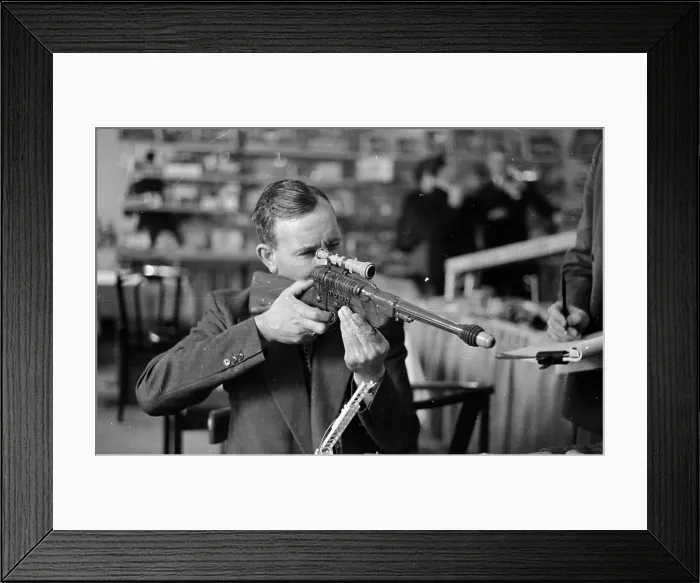 Framed Print : Toy Gun. 10th April 1954: A visitor at the Toy Manufacturers Fair at Brighton Framed Print : Toy Gun. 10th April 1954: A visitor at the Toy Manufacturers Fair at Brighton