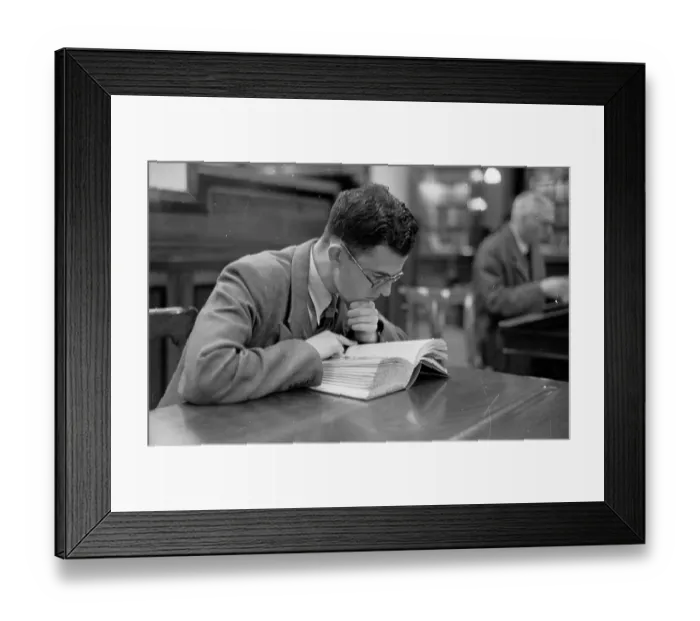 Framed Print : Bookworm. 17th October 1953: A young man perusing a hefty volume in a Glasgow library