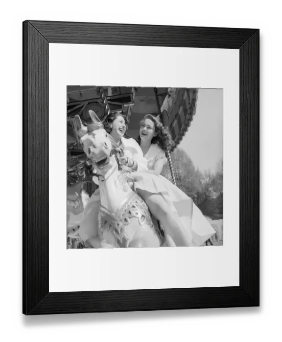 Framed Print : Fun Fair. 20th June 1953: Two young women riding on a merry-go-round at Framed Print : Fun Fair. 20th June 1953: Two young women riding on a merry-go-round at