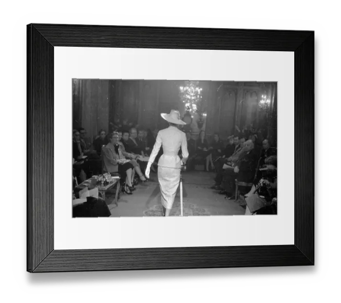 Framed Print : Cat Walk. 28th February 1953: Audience and model at a fashion show given by John Cavanagh Framed Print : Cat Walk. 28th February 1953: Audience and model at a fashion show given by John Cavanagh