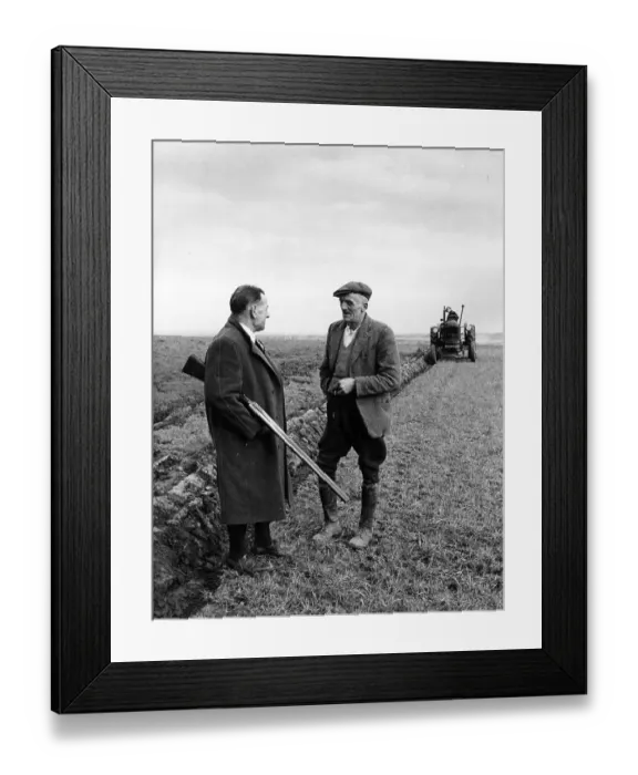 Framed Print : Gun Law. January 1953: A farmer with a double barrelled shotgun talks to Framed Print : Gun Law. January 1953: A farmer with a double barrelled shotgun talks to