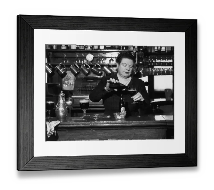 Framed Print : Barmaid. A barmaid pours out a glass of beer Framed Print : Barmaid. A barmaid pours out a glass of beer