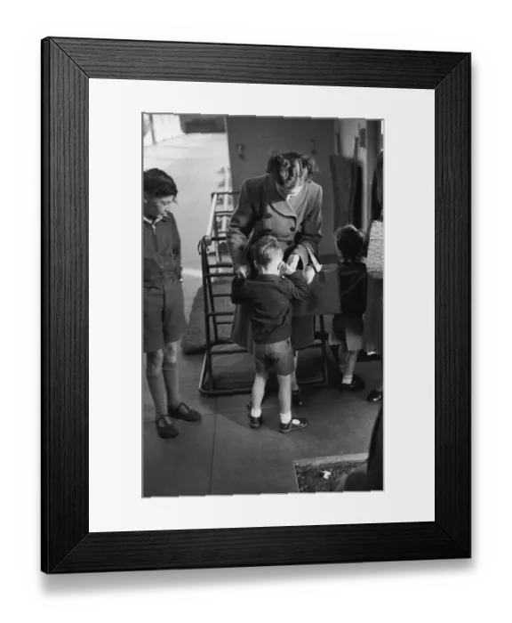 Framed Print : First Day. A five-year-old boy seeks comfort from his mother on his first Framed Print : First Day. A five-year-old boy seeks comfort from his mother on his first