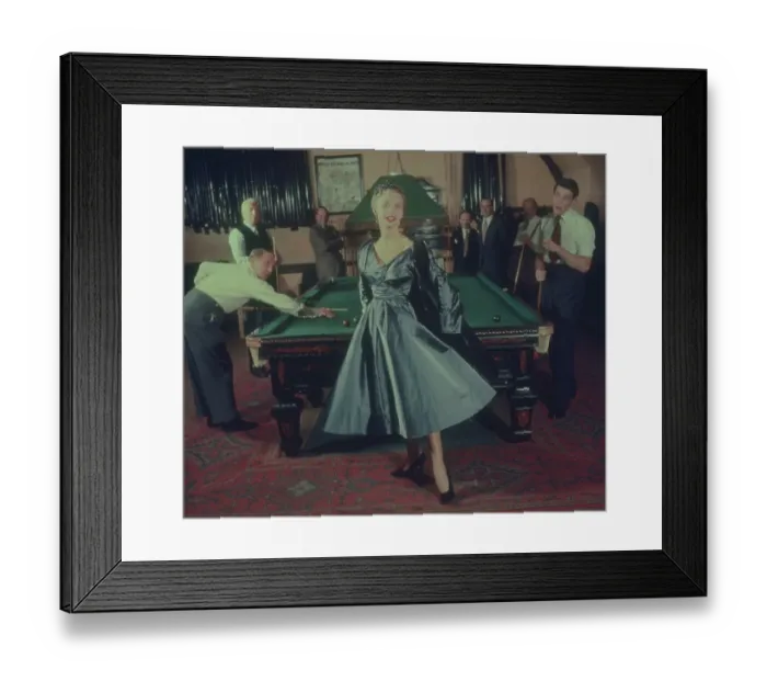 Framed Print : Snookered. A woman models a silver-blue dress and coat, in front of a snooker table Framed Print : Snookered. A woman models a silver-blue dress and coat, in front of a snooker table