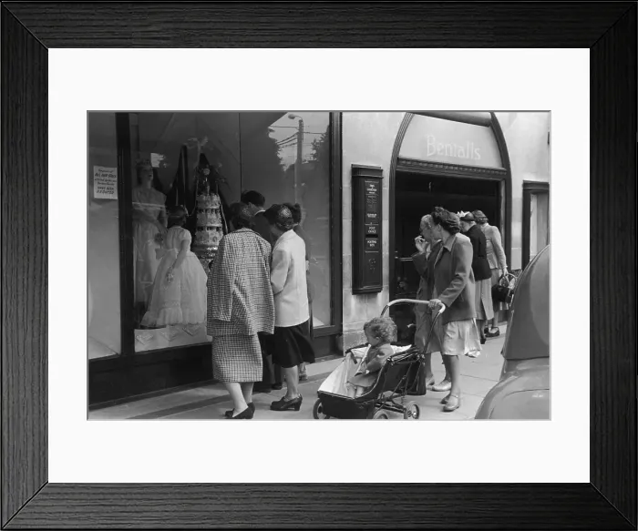 Framed Print : Bentalls. 21st June 1952: Shoppers gaze at a wedding display in the window Framed Print : Bentalls. 21st June 1952: Shoppers gaze at a wedding display in the window