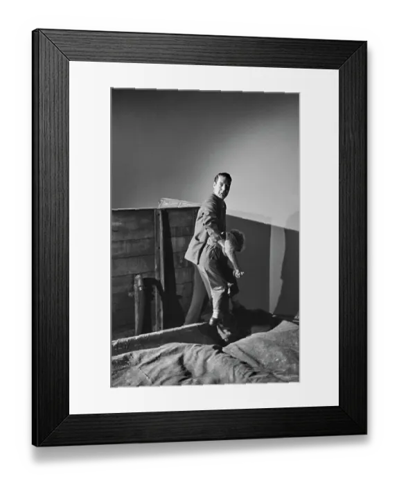Framed Print : Hunted. English film director Charles Crichton carries Scottish child actor Framed Print : Hunted. English film director Charles Crichton carries Scottish child actor