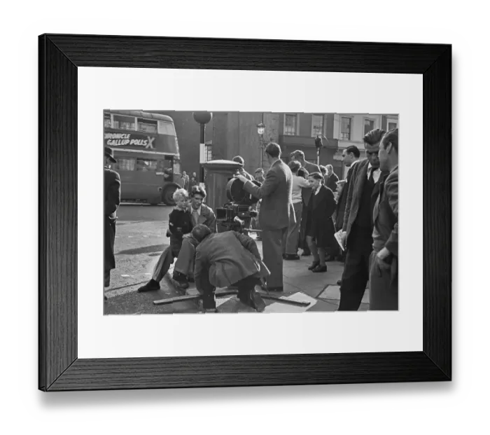 Framed Print : Hunted. Scottish child actor Jon Whiteley sits on the knee of a man during Framed Print : Hunted. Scottish child actor Jon Whiteley sits on the knee of a man during