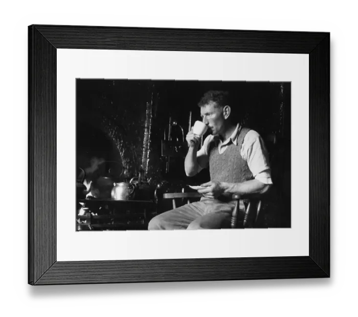 Framed Print : Tea Break. 11th August 1951: A man has a cup of tea by a kitchen range Framed Print : Tea Break. 11th August 1951: A man has a cup of tea by a kitchen range